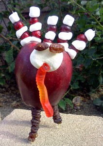 Thanksgiving crafts for kids - make a turkey with an apple, cranberries, raisins, marshmallows and gummy worms