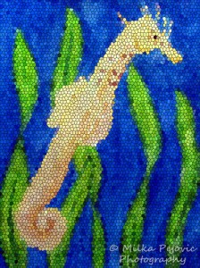 Mosaic of a yellow seahorse swimming underwater
