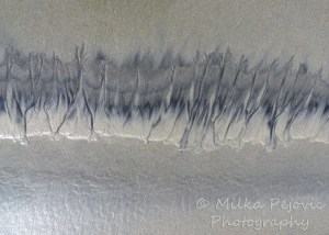 Sand art on the beach in dark and light sand